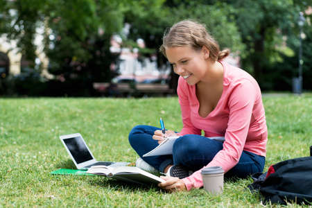 Laughing german female student learning and preparing for degreeの写真素材