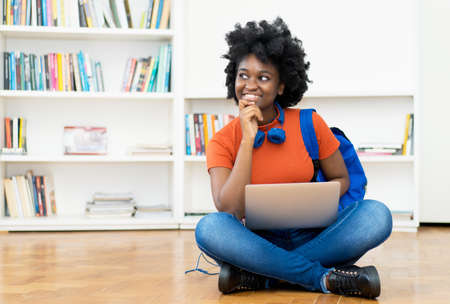 Young african american female student at video call at computerの写真素材