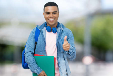 Young Brazilian male student with braces outdoor in city in summerの写真素材