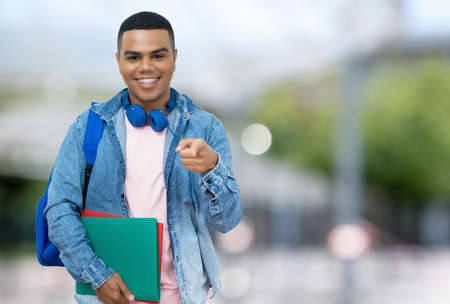 Handsome brazilian male student with braces outdoor in city in summerの写真素材