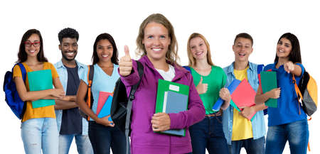 German young adult woman showing thumb up with large group of international studentsの写真素材