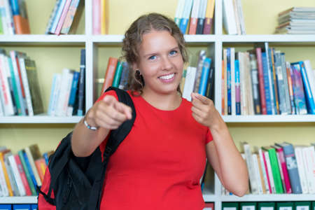 Happy german female student at library of universityの写真素材