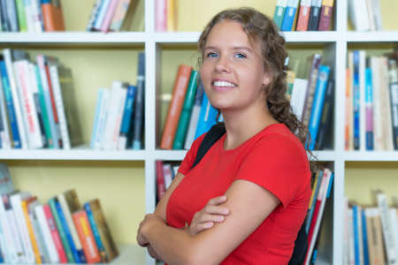 Pretty german female student at library of universityの写真素材