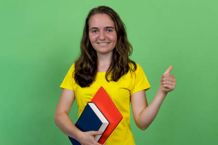 Successful german female student showing thumb up
