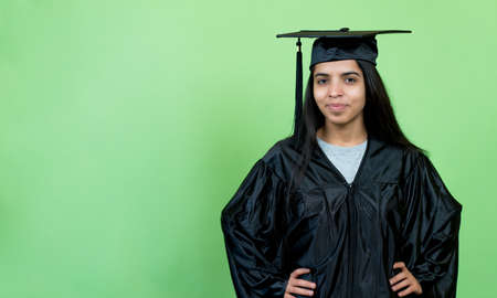 Pretty indian graduate student with academic dress and hatの写真素材