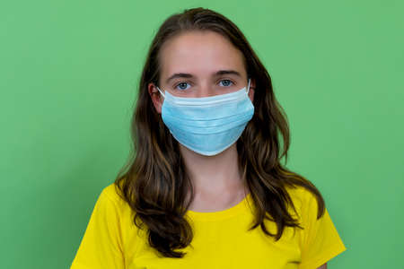 German female young adult with face mask as protection against corona virusの写真素材