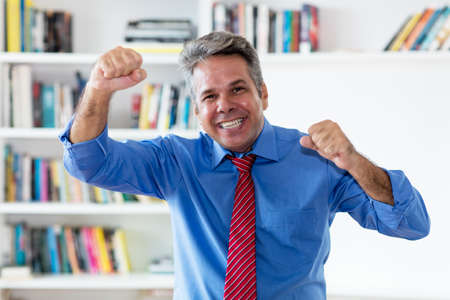 Cheering and laughing businessman with tieの写真素材