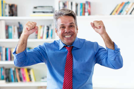 Successful cheering businessman with tieの写真素材