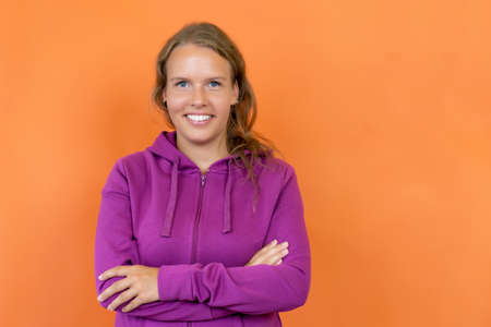 Beautiful blond german young adult woman with hoodyの写真素材