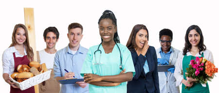 Beautiful african american female nurse with group of trainees isolated on white background for cut outの写真素材