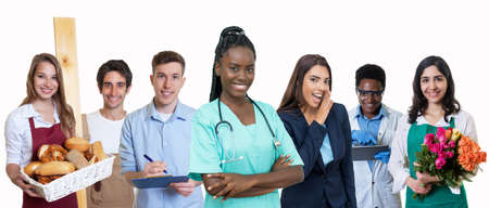 Laughing african american female nurse with group of trainees isolated on white background for cut outの写真素材