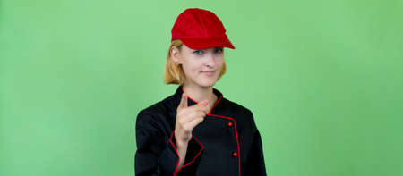 Young female waitress with fashionable uniform of coffee bar or restaurant