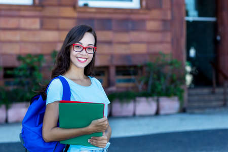 Pretty young female student with long black hair and glassesの写真素材