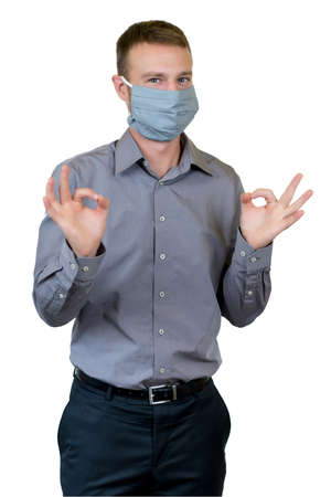 English young adult man with face mask as protection against corona virus infection isolated on white background for cut outの写真素材