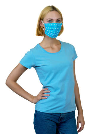 Beautiful woman with blond hair and homemade face mask as protection against covid-19 infection isolated on white background for cut outの写真素材