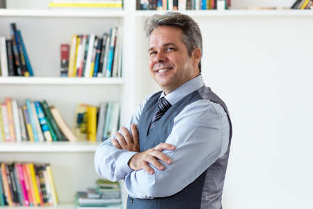Smiling mature adult american businessman with gray hairの写真素材