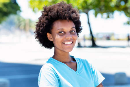 Laughing african american woman in city in summerの写真素材