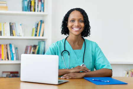 Working african american mature nurse or doctor at clinicの写真素材