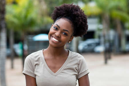 Portrait of funny caribbean woman with afro hair outdoor in summer in cityの写真素材