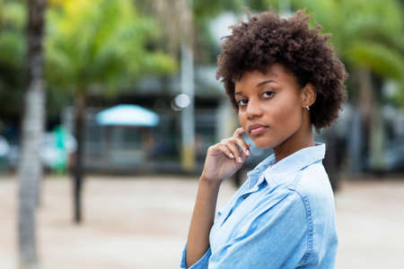 Smiling black woman from Brazil in city in summerの写真素材
