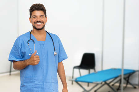 Optimsitic latin american doctor at vaccination station is ready for vacinating patients against coronavirus infectionの写真素材