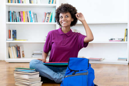 Smart african american female college student indoors at homeの写真素材