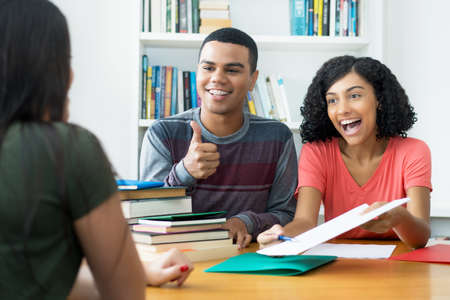 Group of brazilian male and female students learning together at classroom of collegeの写真素材