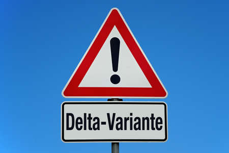 Warning sign with sky and German word for covid-19 delta variantの写真素材