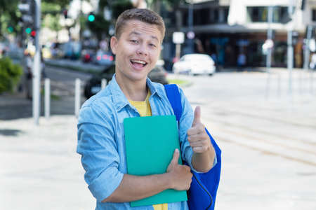 German male student showing thumb upの写真素材