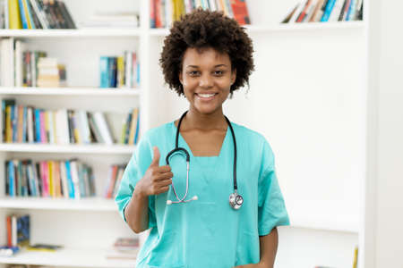 Optimistic afro american female nurse at work at hospitalの写真素材