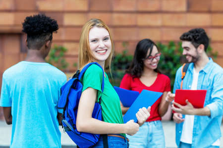 Laughing British female student with group of studentsの写真素材
