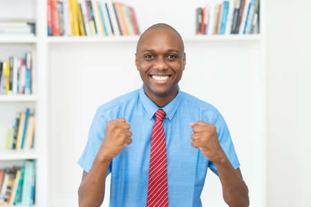 Portrait of a cheering african american businessman at officeの写真素材