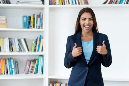 Motivated mexican female business trainee at the office of companyの写真素材