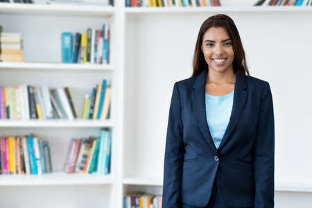 Laughing mexican female business trainee at the office of companyの写真素材