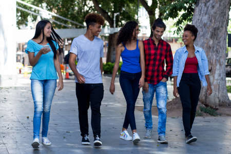 Talking group of brazilian and mexican hipster young adults in city in summerの写真素材