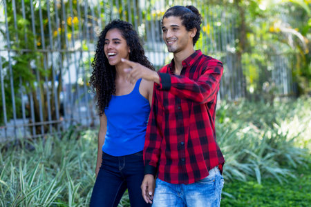 Laughing brazilian hipster couple in city in summerの写真素材