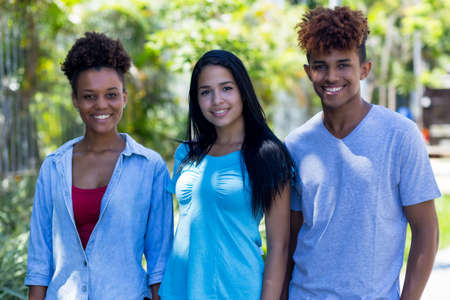 Portrait of mexican and brazilian young adults in city in summerの写真素材