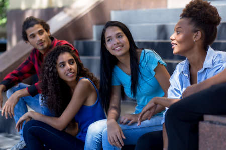Group of young latin american and hispanic immigrants in city in summerの写真素材