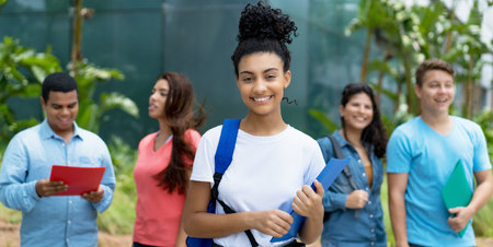 Laughing indian female student with group of multi ethnic young adults outdoor in cityの写真素材