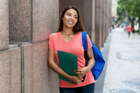 Young latin female student with scholarship in America outdoor in summer in cityの写真素材