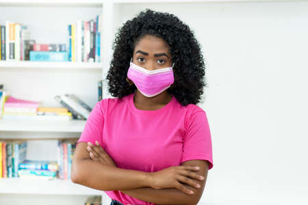 African american woman with pink face maskの写真素材