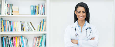 Pretty mexican female doctor with copy space at clinicの写真素材