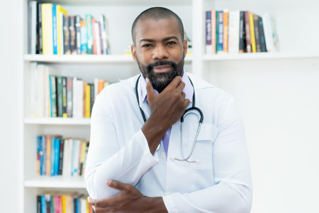 Serious african american doctor with beard and stethoscope at office of hospitalの写真素材