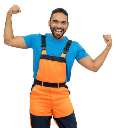 Cheering hispanic construction worker with orange protective gear isolated on white background for cut outの写真素材