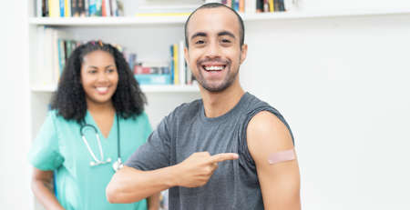 Laughing mexican man after third vaccination