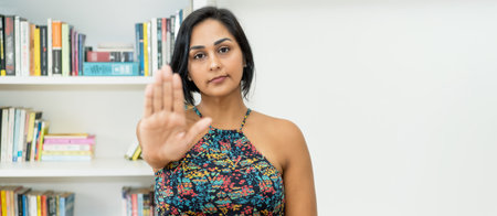 Hispanic mature adult woman gesturing stop with hand