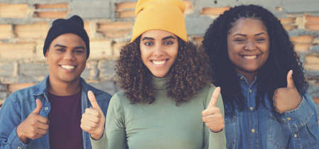 Beautiful laughing latin american woman showing thumb upの写真素材