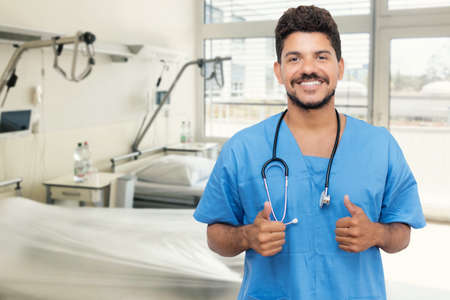 Optimistic mexican male nurse or doctor with beard at hospitalの写真素材