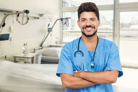 Handsome mexican male nurse or doctor with beard at hospitalの写真素材