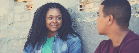 Corpulent african american young woman talking with boyfriend outdoor in urban city styleの写真素材